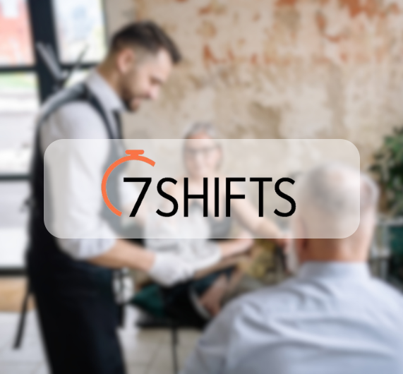 7shifts logo with image of waiter serving couple at restaurant